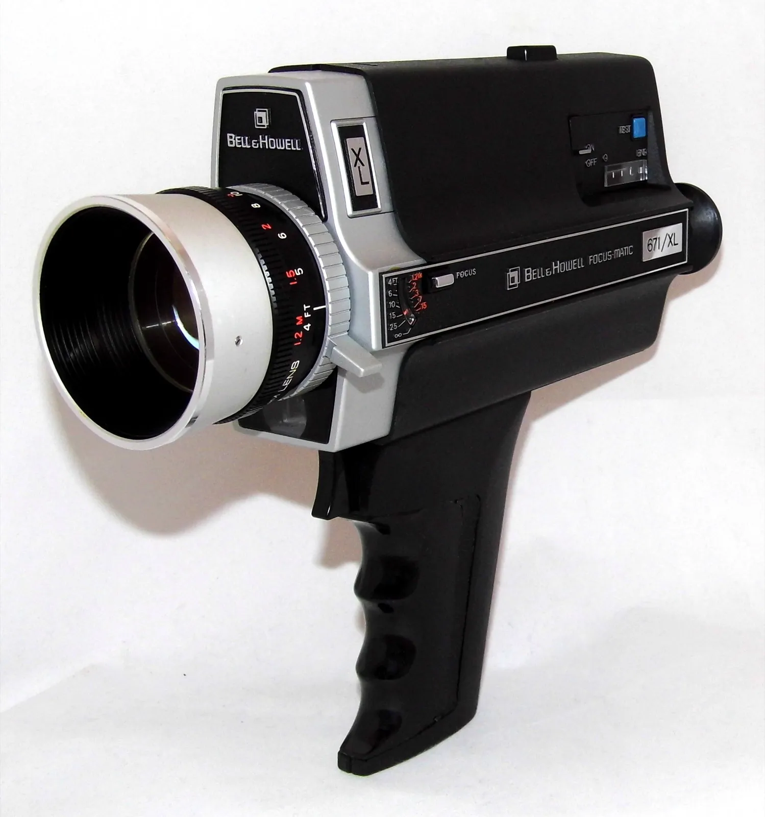 A black and silver Bell & Howell Super 8 home movie camera with a pistol grip