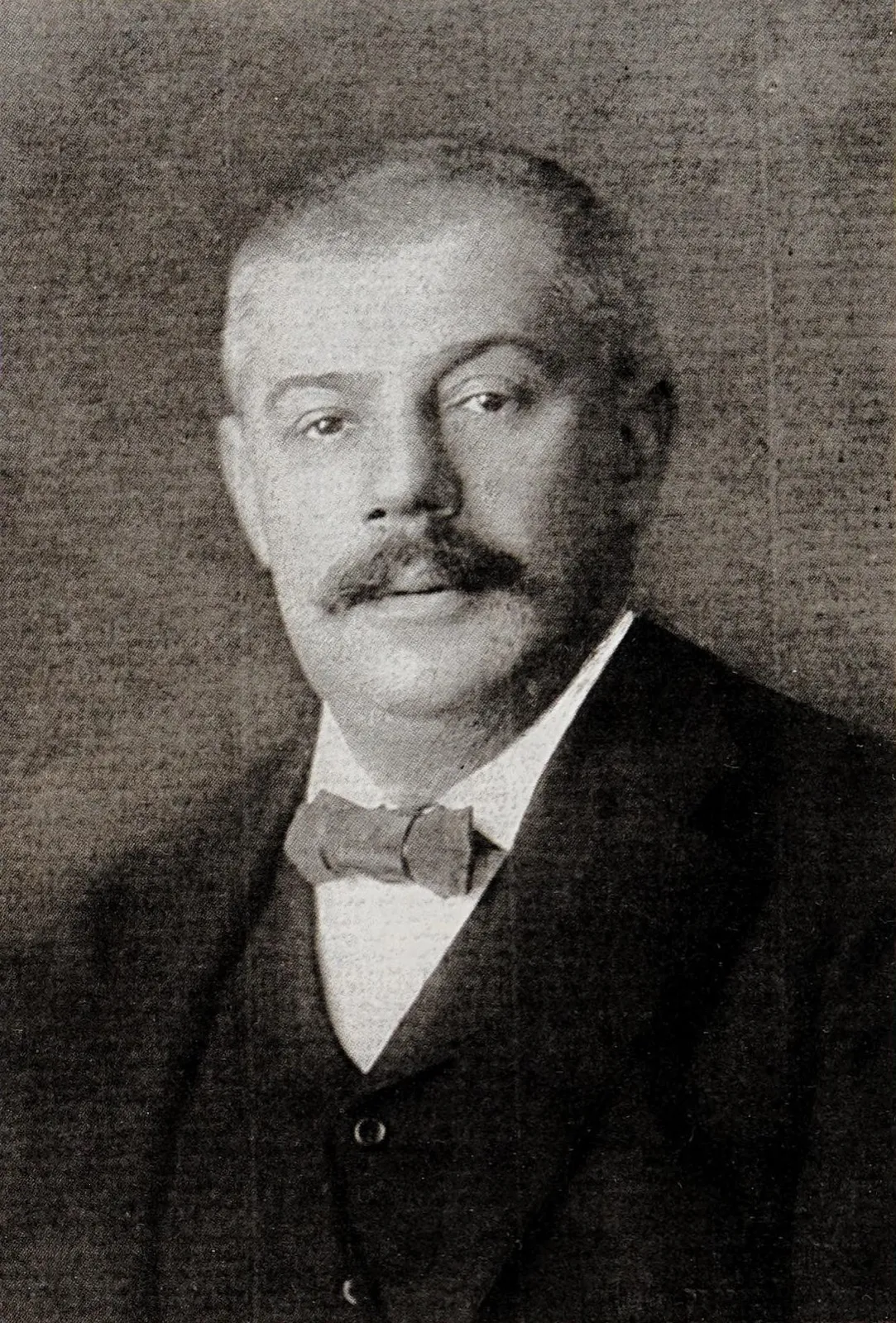 Hermann Kafka, a heavy-set man with a large moustache and bow tie, in a formal studio portrait