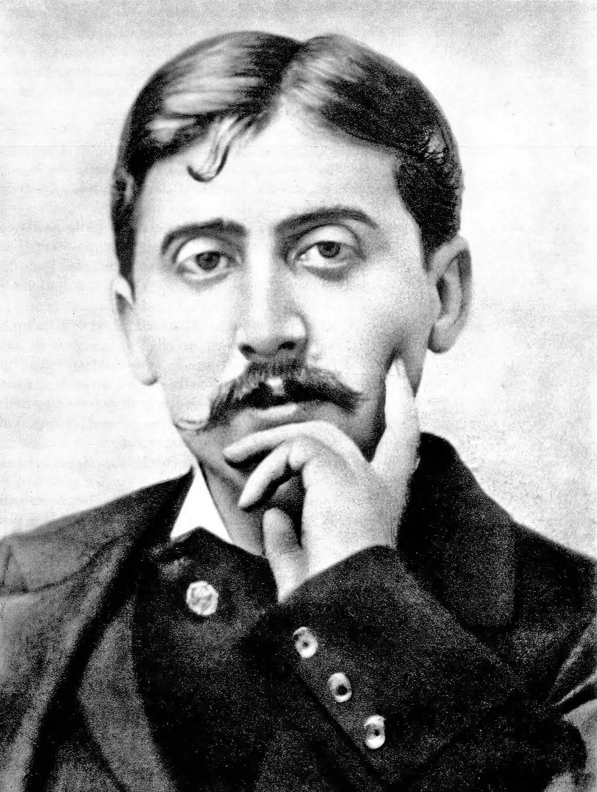 A black and white portrait of a young Marcel Proust with a moustache, his chin resting on his hand